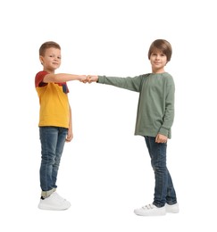 Photo of Cute brothers making fist bump on white background