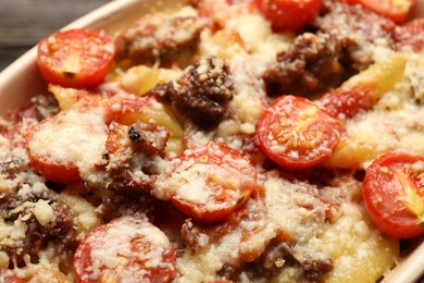 Photo of Delicious pasta casserole with cheese, tomatoes and minced meat in baking dish, closeup