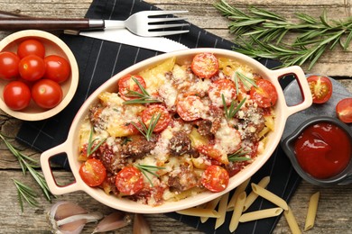 Photo of Flat lay composition with delicious pasta casserole in baking dish on wooden table