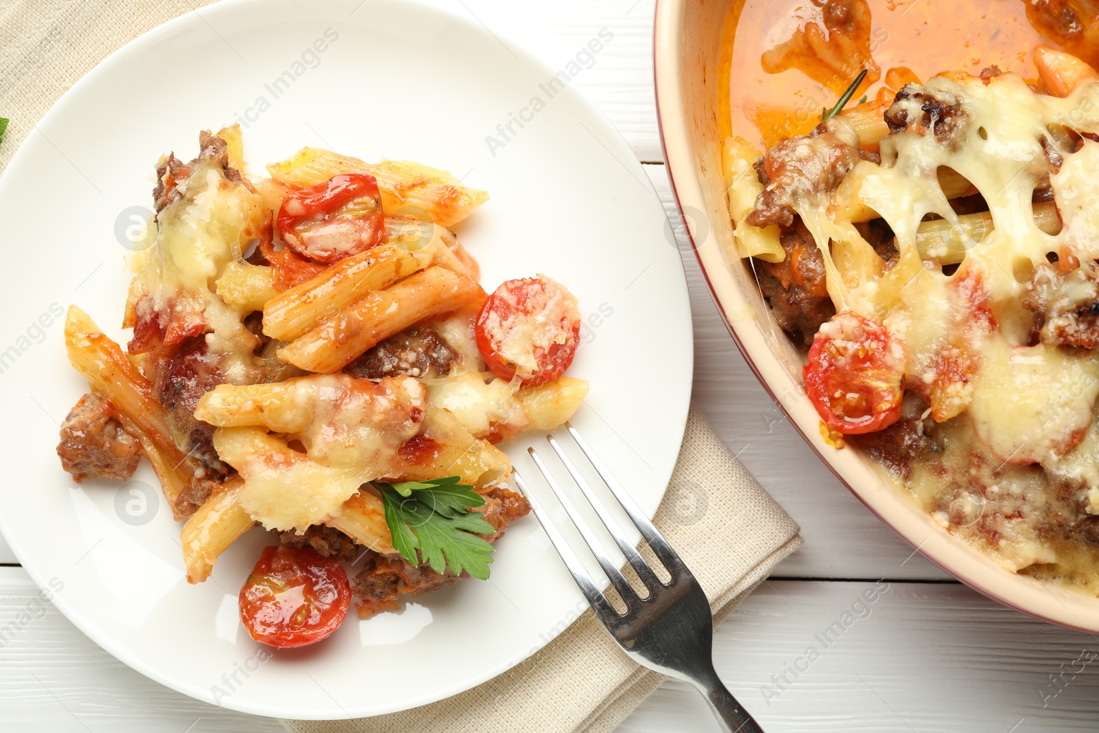 Photo of Flat lay composition with delicious pasta casserole served on white wooden table