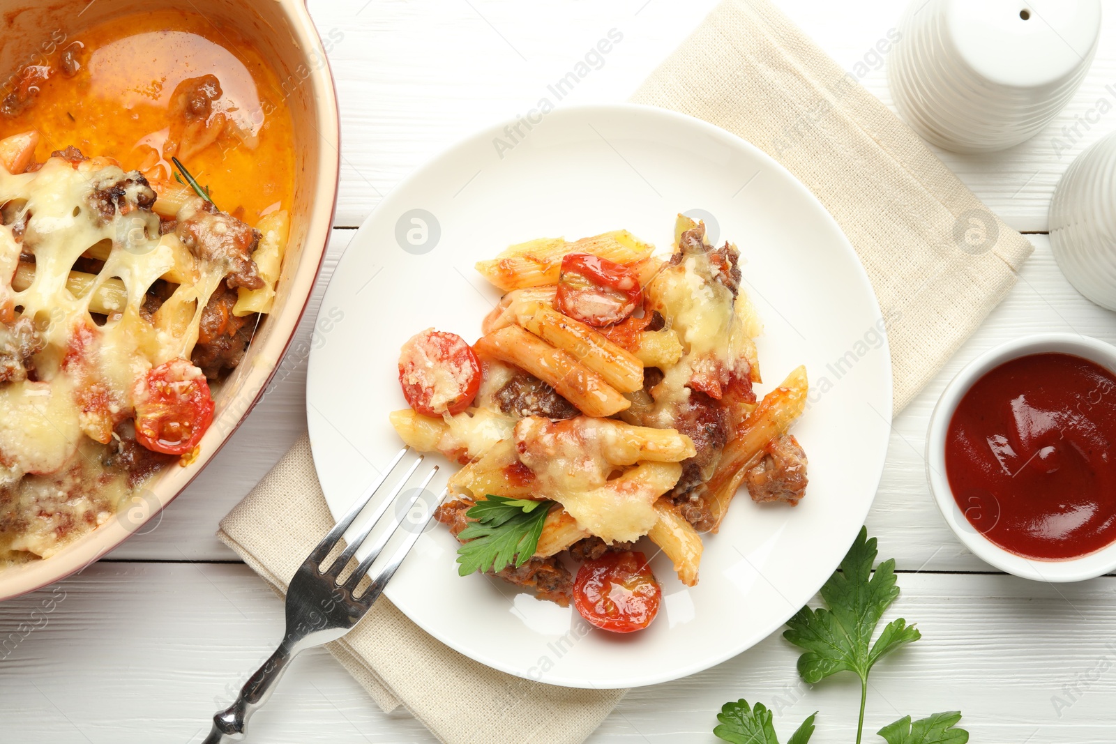 Photo of Flat lay composition with delicious pasta casserole served on white wooden table