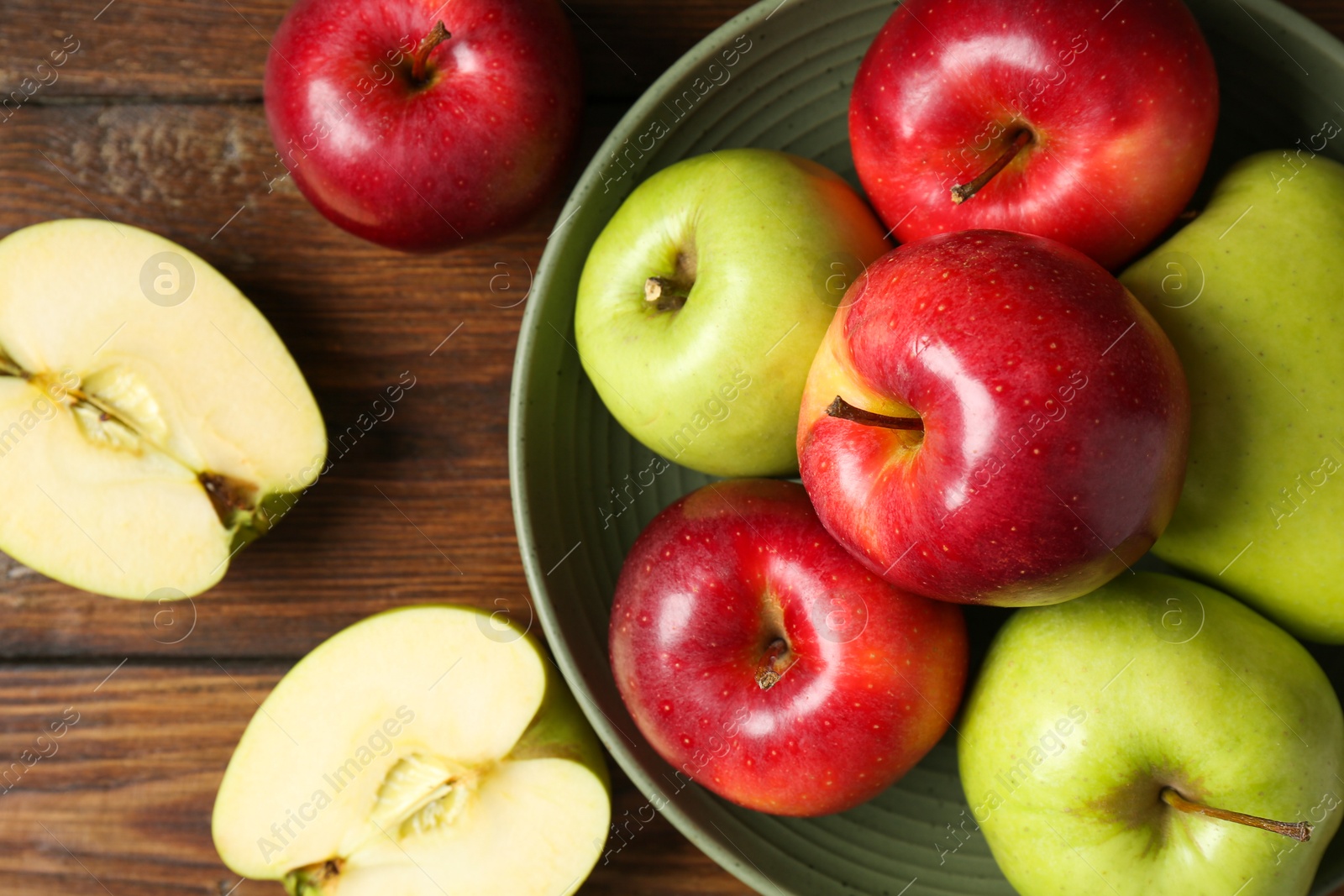 Photo of Fresh red and green apples on wooden table, flat lay