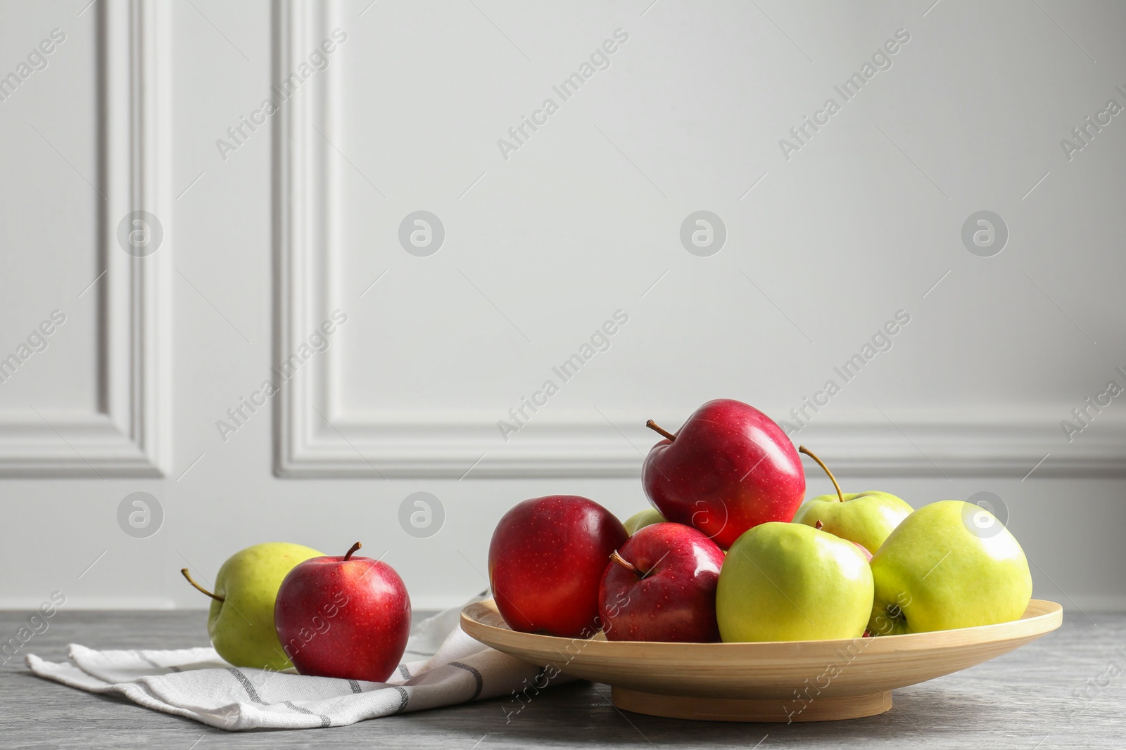 Photo of Fresh red and green apples on grey table