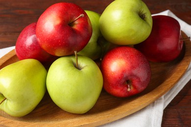 Photo of Fresh red and green apples on wooden table, closeup