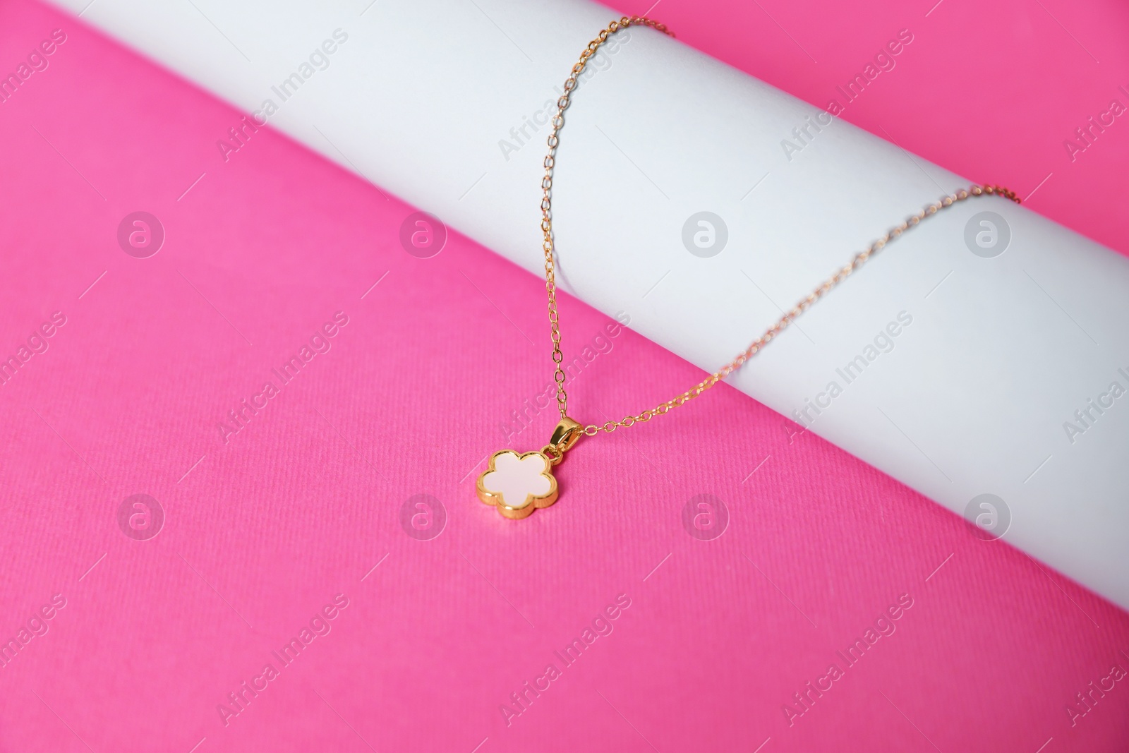 Photo of Stylish presentation of beautiful necklace on pink background