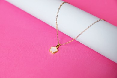 Photo of Stylish presentation of beautiful necklace on pink background