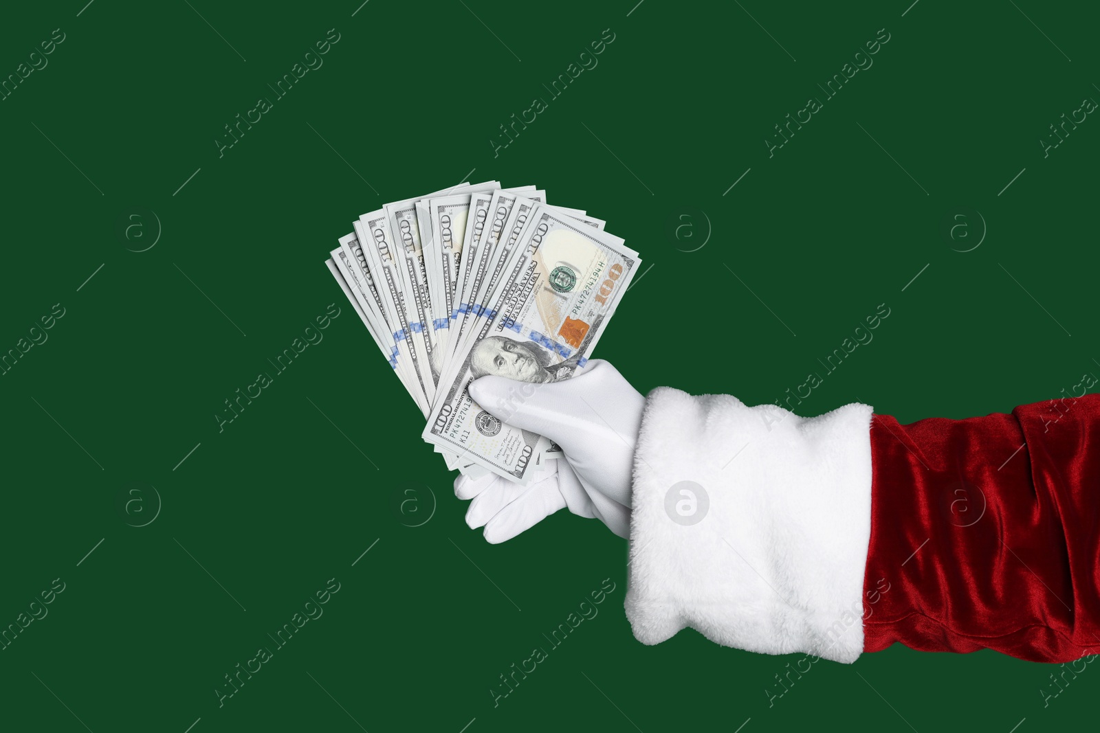 Photo of Santa Claus holding dollar banknotes on green background, closeup. Space for text