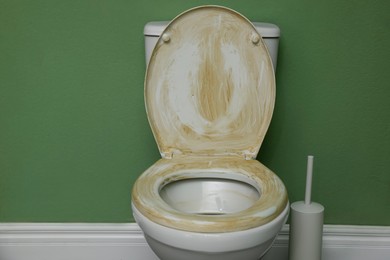 Photo of Toilet with dirty seat in public restroom