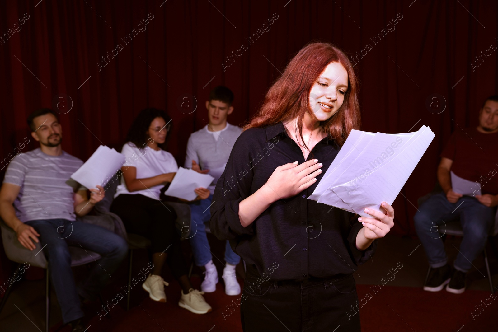 Photo of Professional actress rehearsing on stage in theatre