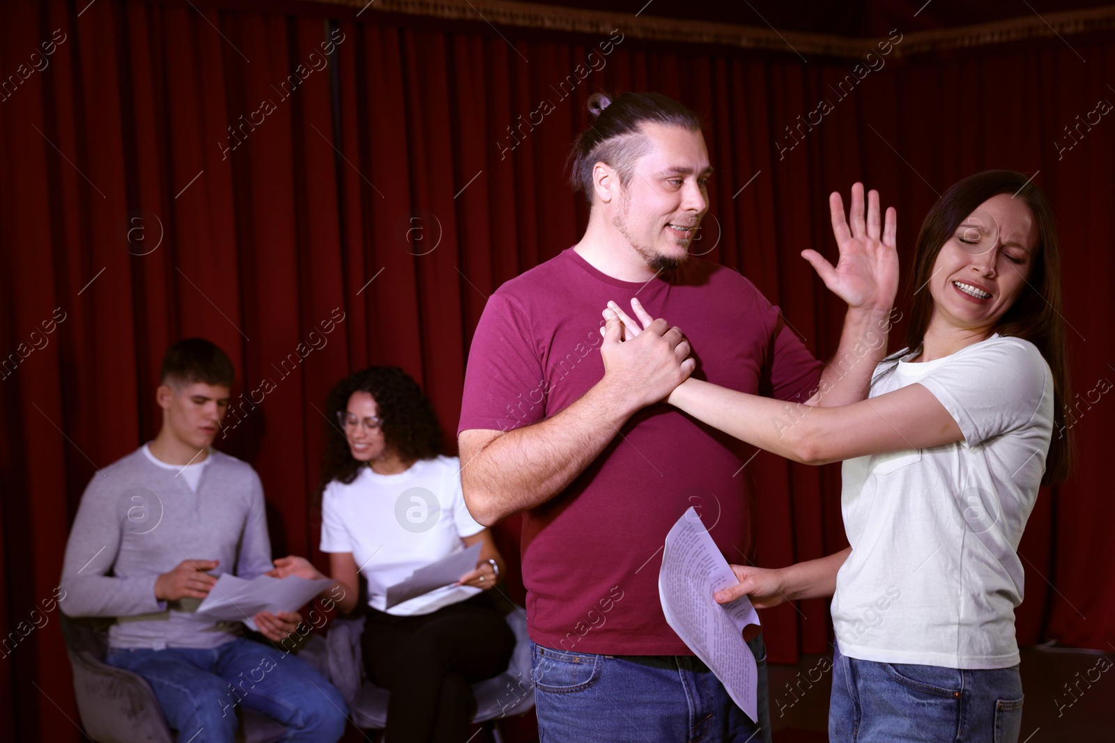 Photo of Professional actors rehearsing on stage in theatre