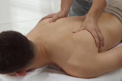 Photo of Massage therapist working with patient in clinic, closeup