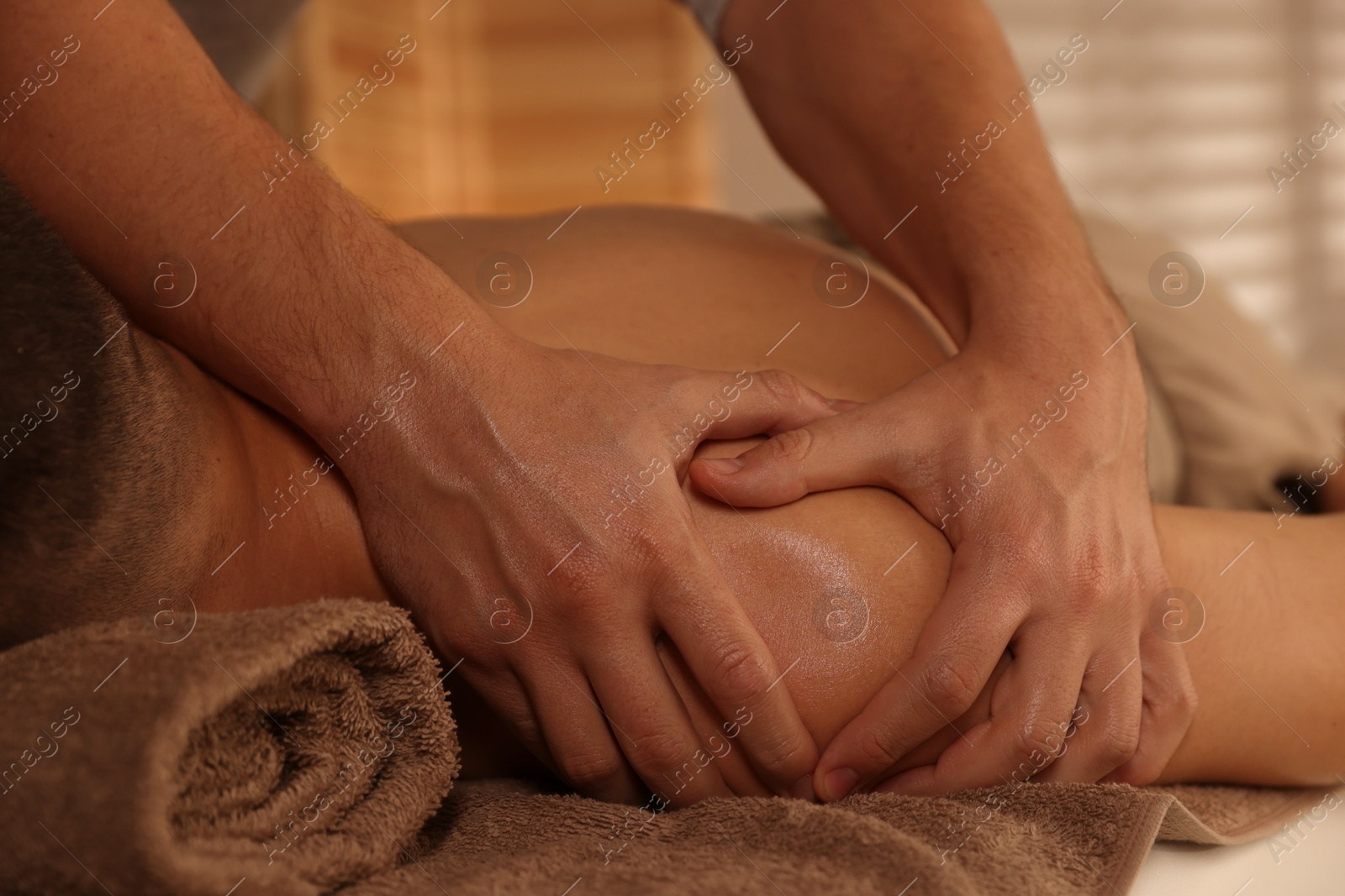 Photo of Massage therapist working with patient in clinic, closeup