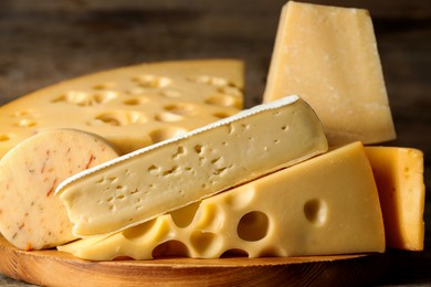 Photo of Different types of cheese on table, closeup