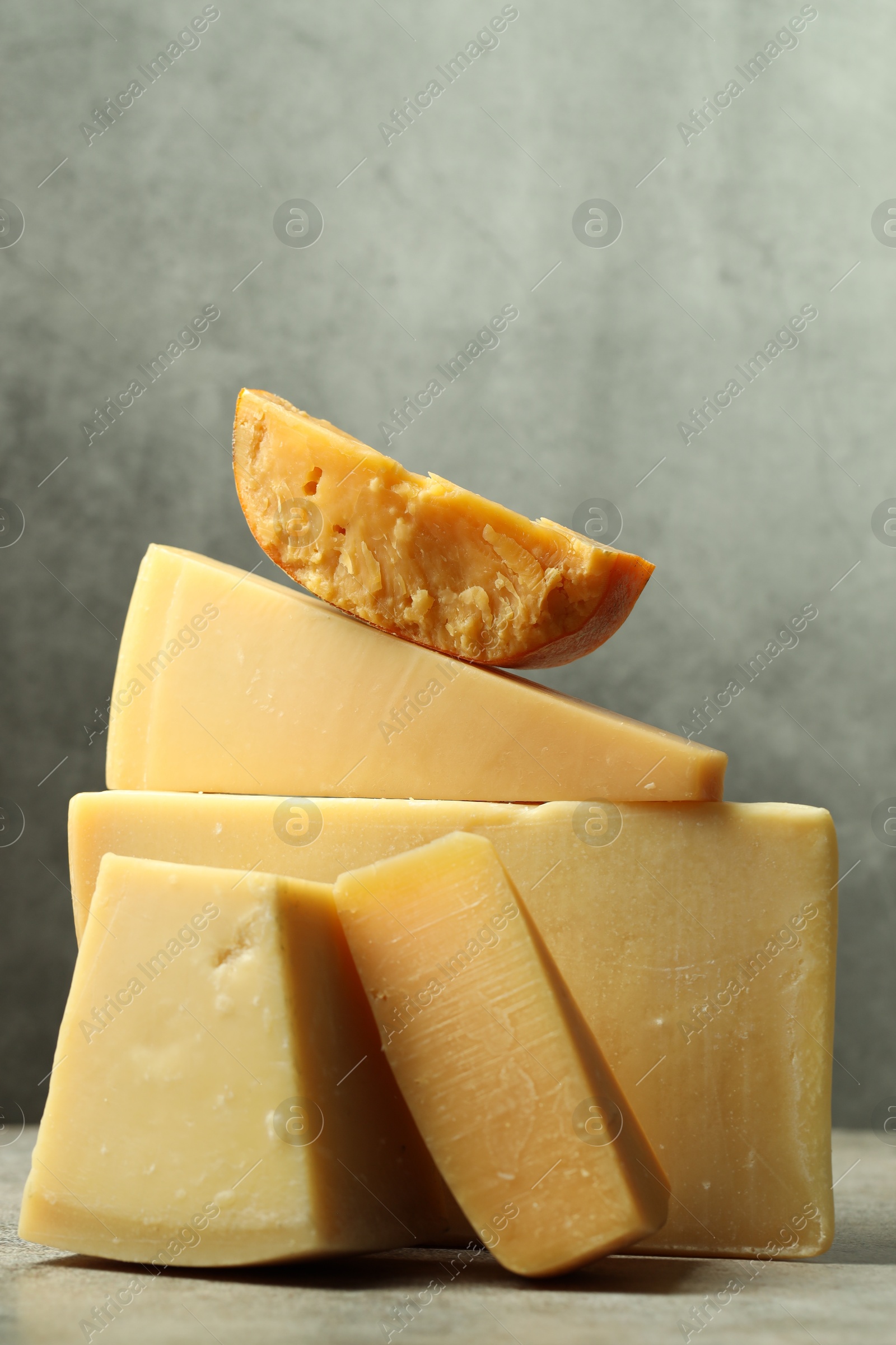 Photo of Different types of cheese on grey table