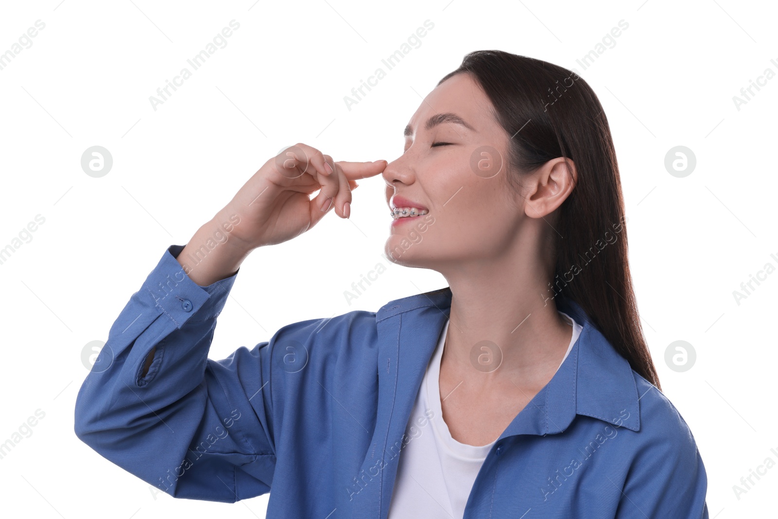 Photo of Young woman touching her nose on white background