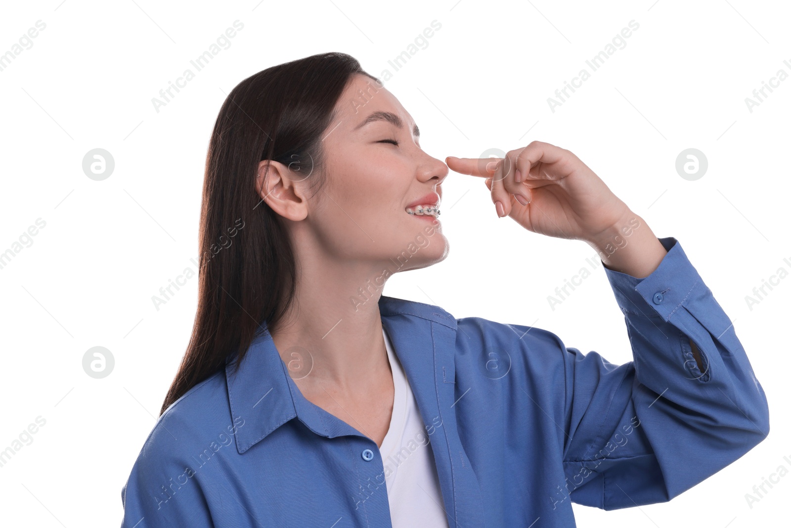 Photo of Young woman touching her nose on white background