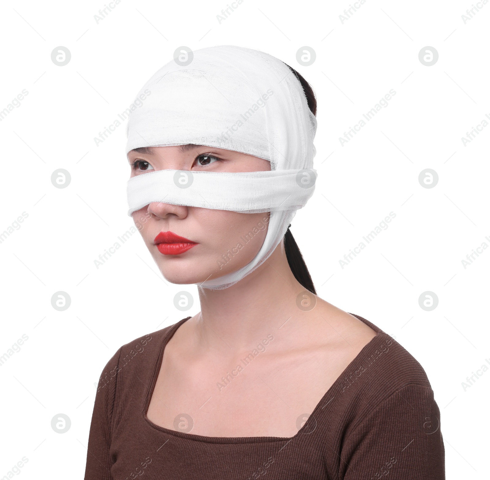 Photo of Woman with nose wrapped in medical bandage after plastic surgery operation on white background