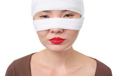 Photo of Woman with nose wrapped in medical bandage after plastic surgery operation on white background, closeup