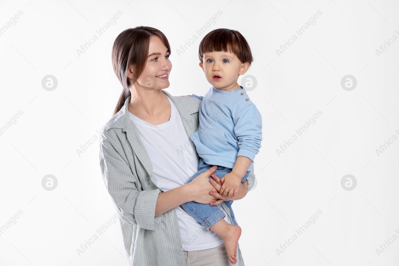 Photo of Beautiful mother with her cute little son on light grey background