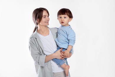 Photo of Beautiful mother with her cute little son on light grey background