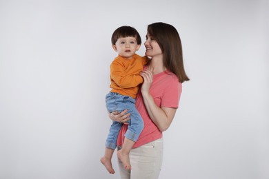 Photo of Happy mother with her cute little son on white background