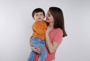 Photo of Happy mother with her cute little son on white background