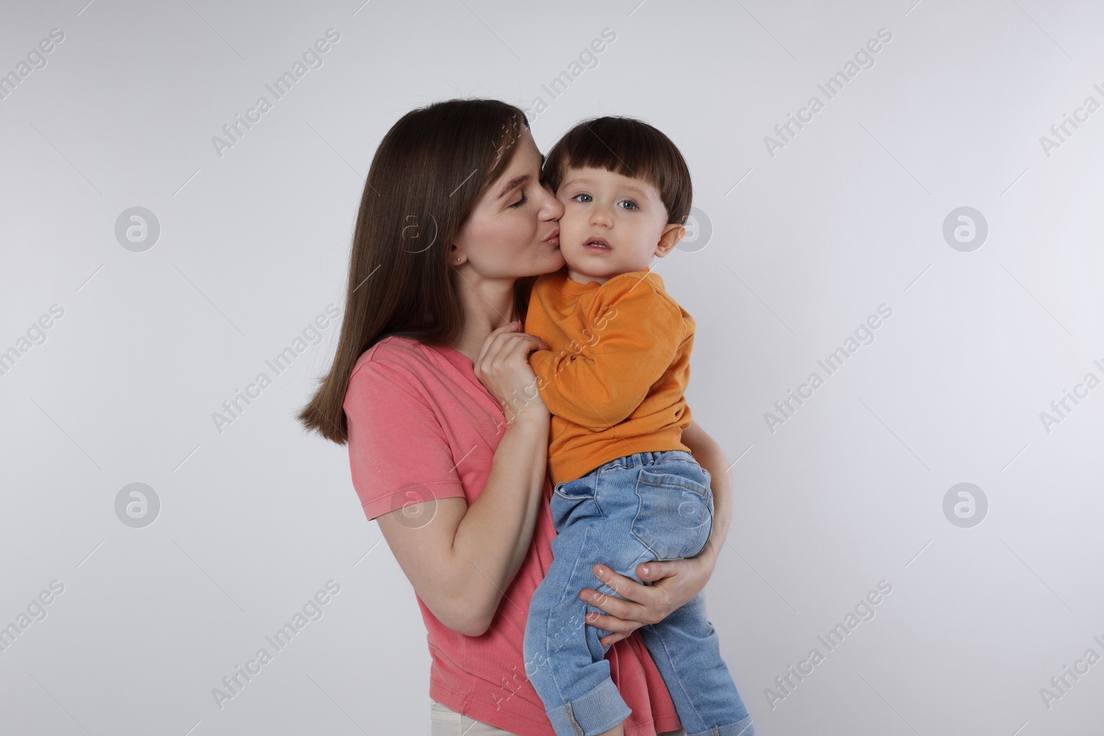 Photo of Beautiful mother with her cute little son on white background