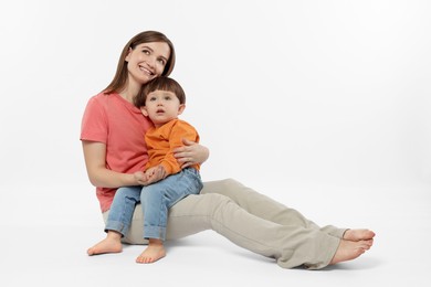 Photo of Happy mother with her cute little son on white background