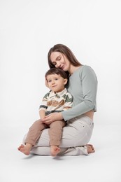 Photo of Happy mother with her cute little son on white background