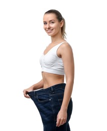 Photo of Weight loss. Happy woman wearing big jeans on white background