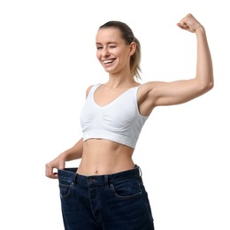 Photo of Weight loss. Happy woman wearing big jeans on white background