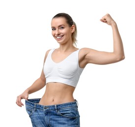 Photo of Weight loss. Happy woman wearing big jeans on white background