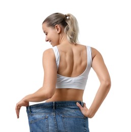 Photo of Weight loss. Happy woman wearing big jeans on white background