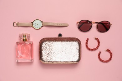 Photo of Stylish jewelry, perfume and accessories on pink background, flat lay