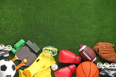 Different sport equipment on artificial grass, flat lay. Space for text