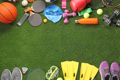 Photo of Different sport equipment on artificial grass, flat lay. Space for text