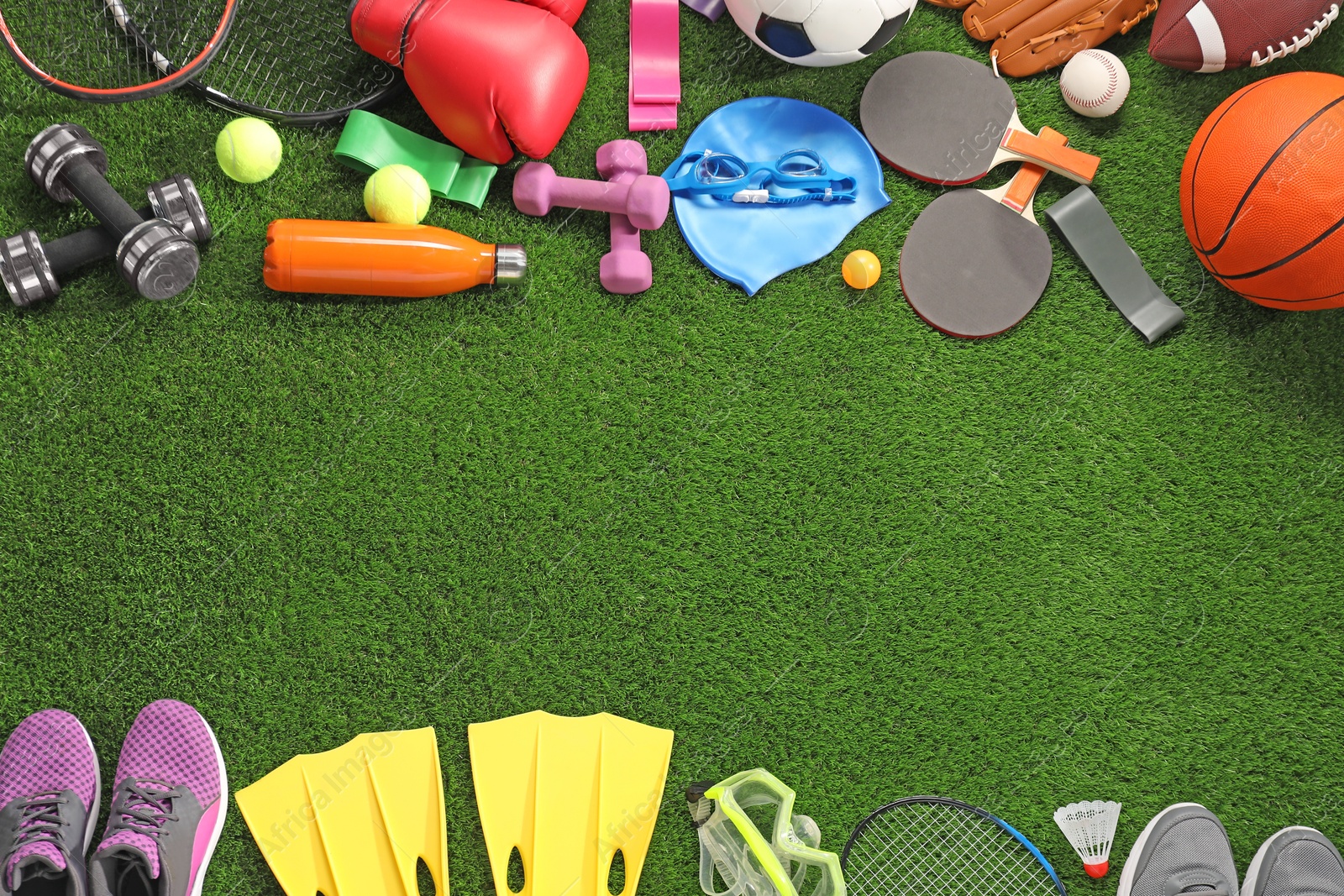 Photo of Different sport equipment on artificial grass, flat lay. Space for text