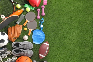 Different sport equipment on artificial grass, flat lay. Space for text