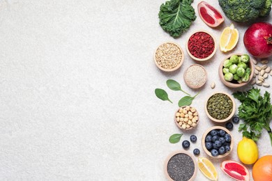 Photo of Different superfood products on light table, flat lay. Space for text