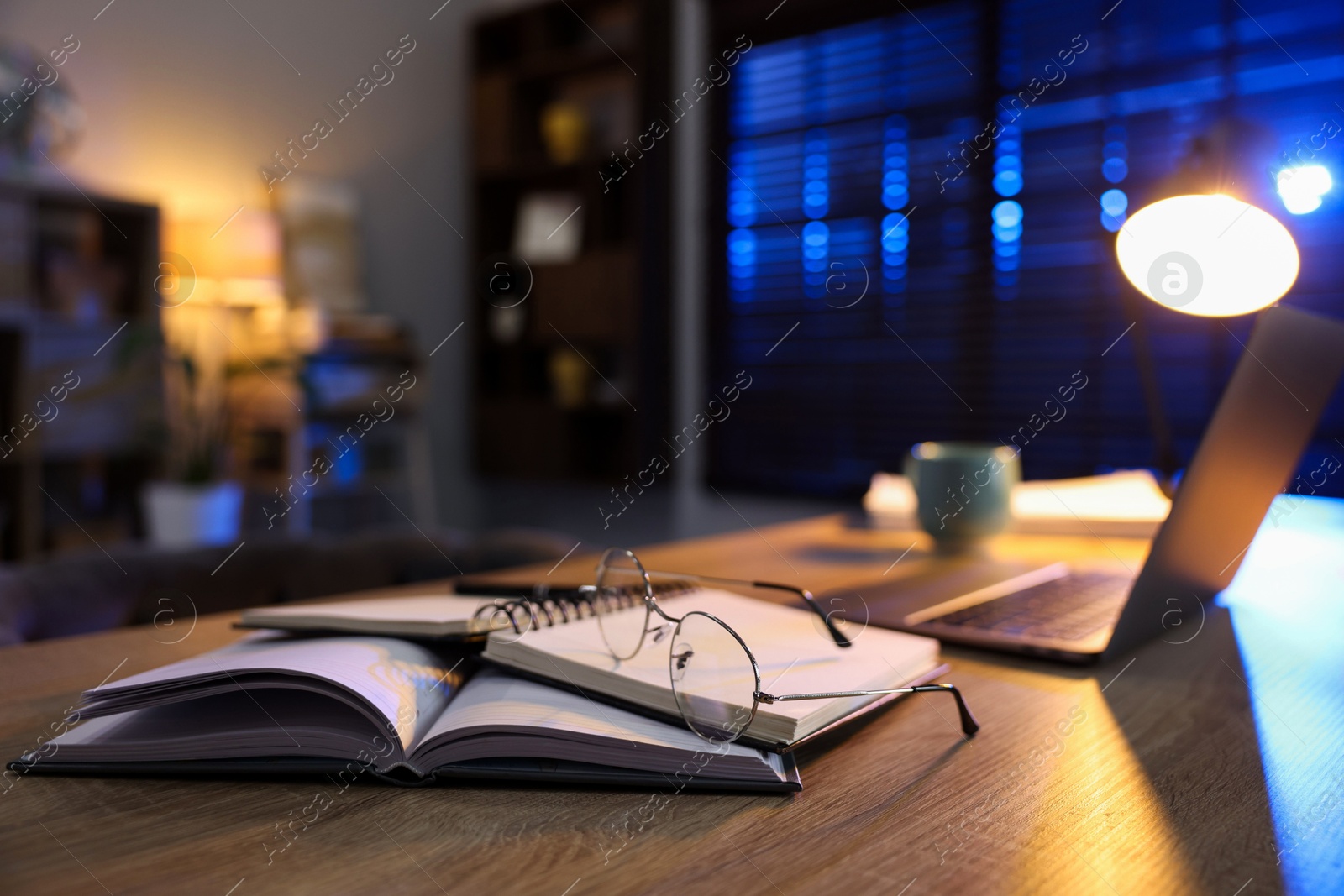 Photo of Workspace with laptop on wooden desk in home office, selective focus. Space for text