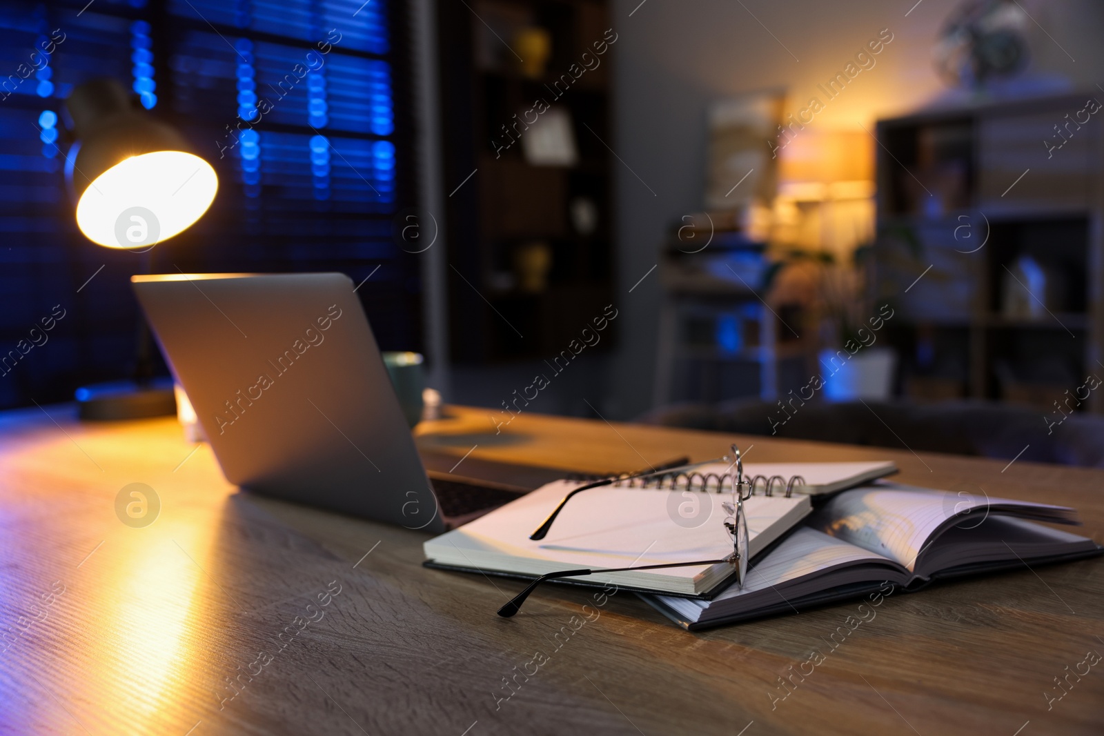 Photo of Workspace with laptop on wooden desk in home office, selective focus. Space for text