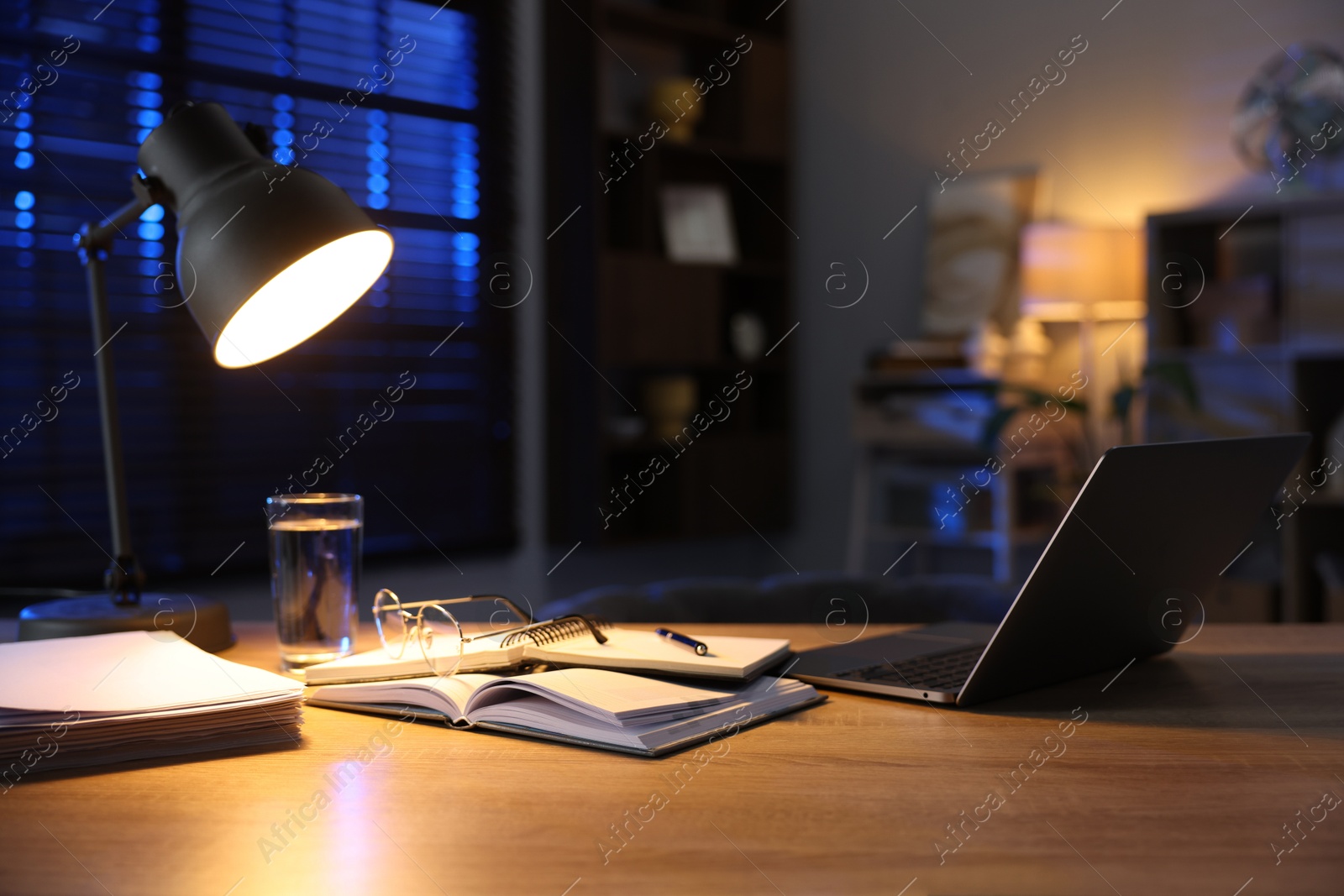 Photo of Workspace with laptop on wooden desk in home office. Space for text