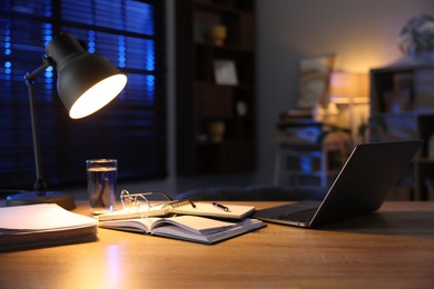 Workspace with laptop on wooden desk in home office. Space for text