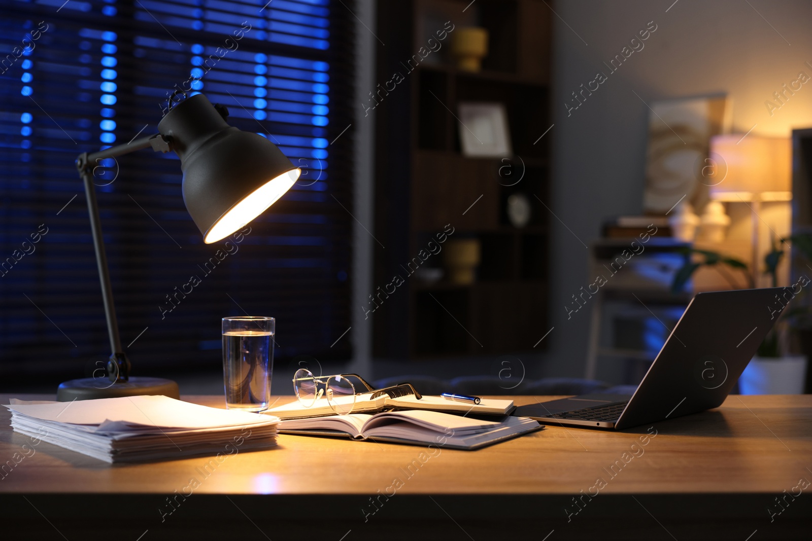 Photo of Workspace with laptop on wooden desk in home office. Space for text