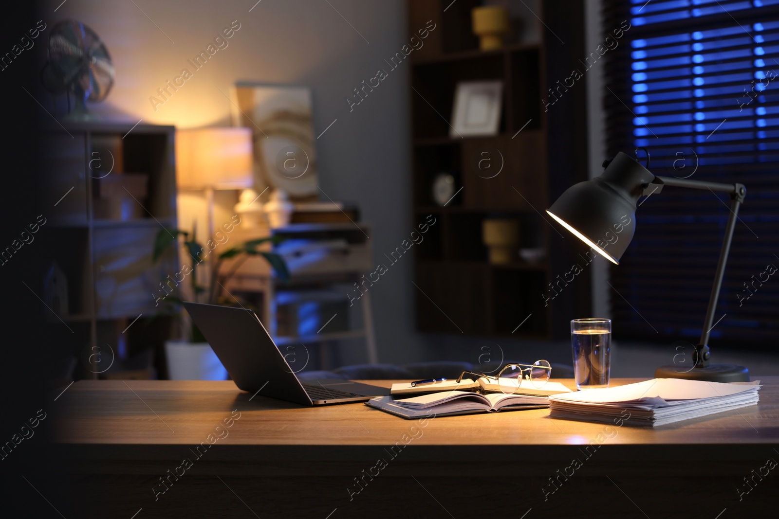 Photo of Workspace with laptop on wooden desk in home office. Space for text