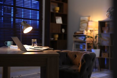 Workspace with laptop on wooden desk in home office