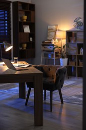 Photo of Workspace with laptop on wooden desk in home office