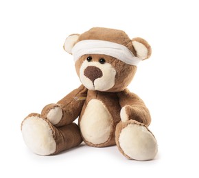 Photo of Teddy bear with bandage and thermometer isolated on white