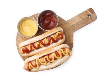 Photo of Tasty hot dogs with ketchup and mustard isolated on white, top view