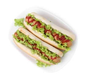 Photo of Tasty hot dogs with lettuce and ketchup isolated on white, top view